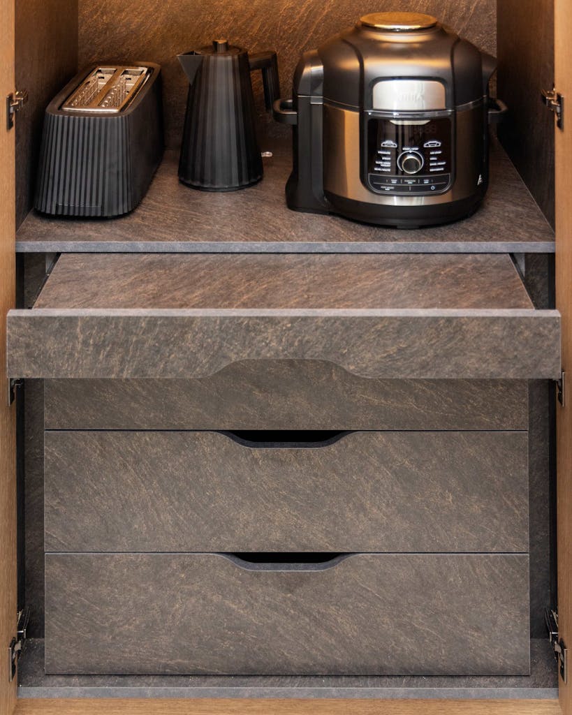 Bespoke modern kitchen in Esher with fluted oak cabinetry and leathered stone island by HUX London