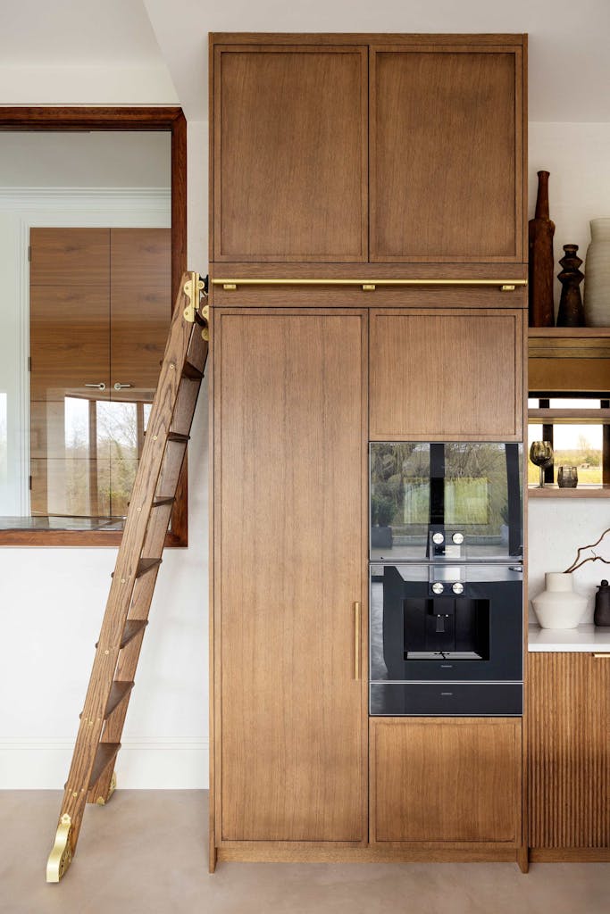 Bespoke modern kitchen in Esher with fluted oak cabinetry and leathered stone island by HUX London