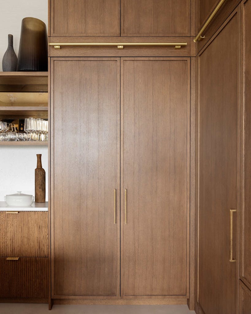 Bespoke modern kitchen in Esher with fluted oak cabinetry and leathered stone island by HUX London
