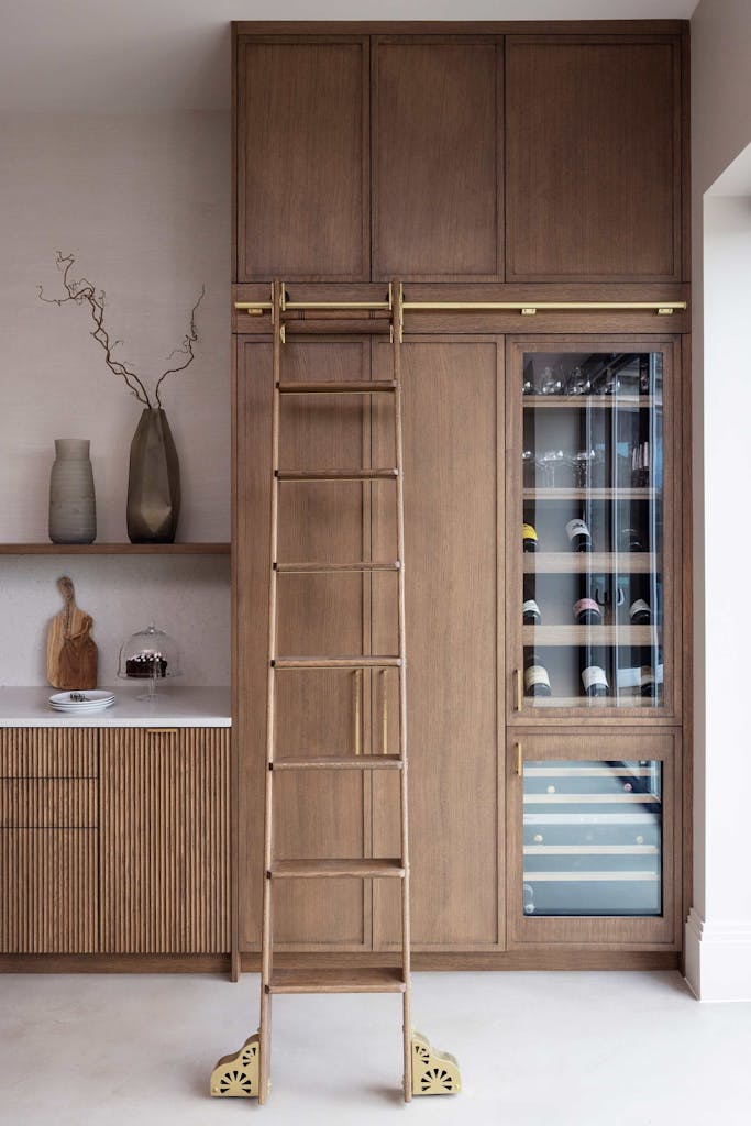 Bespoke modern kitchen in Esher with fluted oak cabinetry and leathered stone island by HUX London