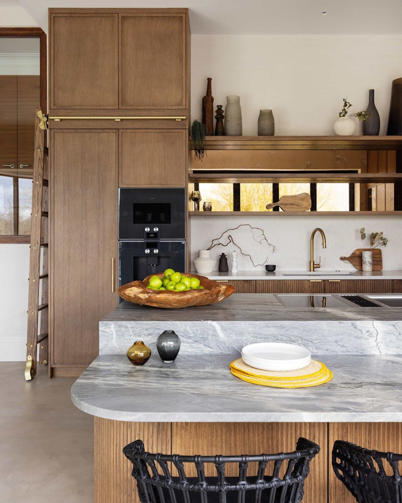 Bespoke modern kitchen in Esher with fluted oak cabinetry and leathered stone island by HUX London