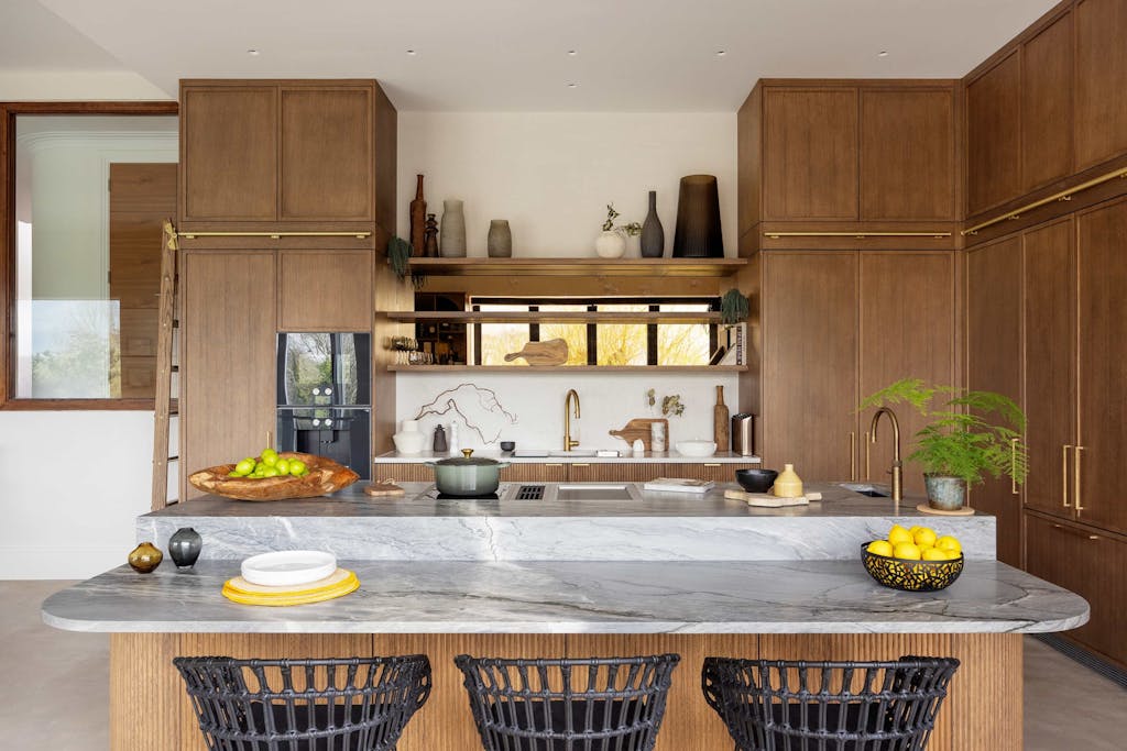 Bespoke modern kitchen in Esher with fluted oak cabinetry and leathered stone island by HUX London