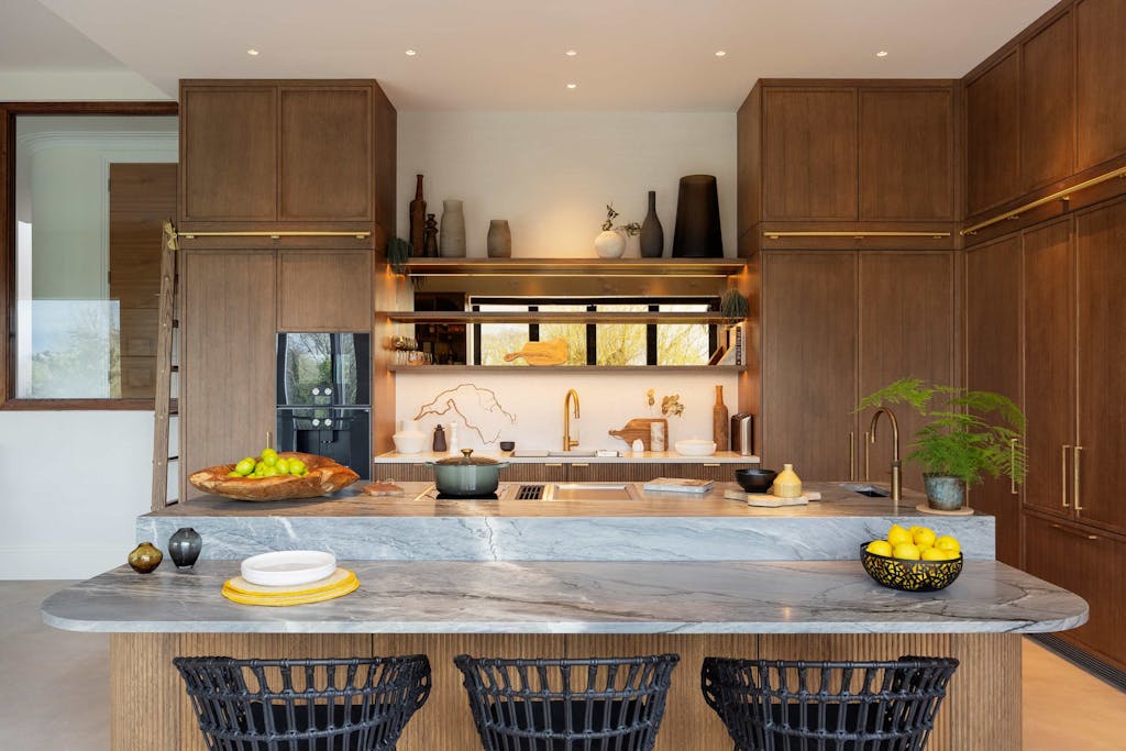 Bespoke modern kitchen in Esher with fluted oak cabinetry and leathered stone island by HUX London