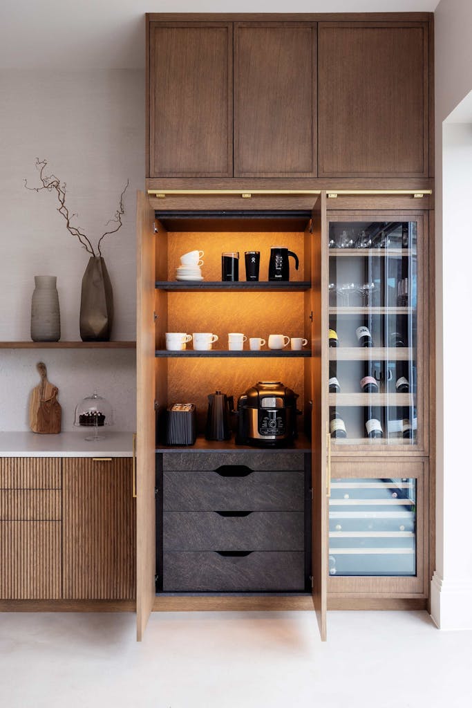 Bespoke modern kitchen in Esher with fluted oak cabinetry and leathered stone island by HUX London
